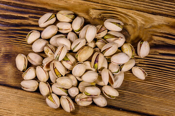 Pile of pistachio nuts on a wooden table