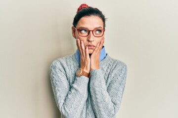 Young caucasian woman wearing casual clothes and glasses tired hands covering face, depression and sadness, upset and irritated for problem