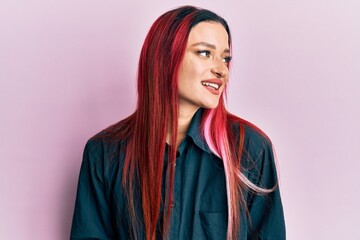 Young caucasian woman wearing casual clothes looking to side, relax profile pose with natural face and confident smile.