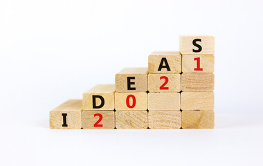 Business concept of 2021 new year ideas. Wooden blocks with words 'Ideas 2021'. Beautiful white...