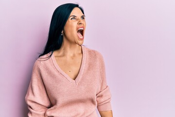 Fototapeta premium Young caucasian woman wearing casual clothes angry and mad screaming frustrated and furious, shouting with anger. rage and aggressive concept.