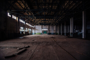 Abandoned large industrial hall with garbage waiting for demolition