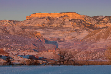 Horse drive in winter on Hideout Ranch, Shell, Wyoming. Last light on Big Horn Mountains