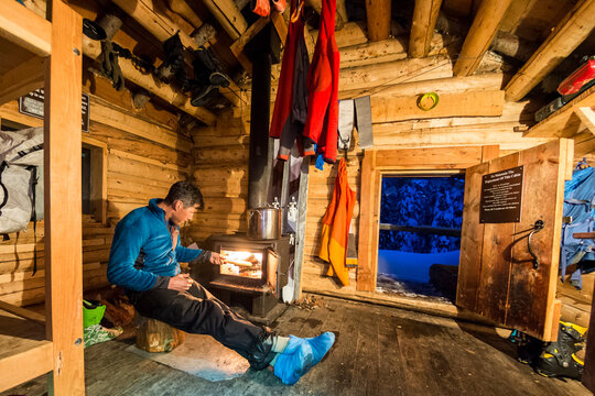 A man staying at the Copper Hut on the Bonnington Traverse, Selkirk Mountains, Columbia Mountains, Nelson, British Columbia.