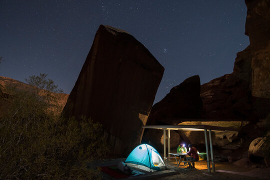 a couple camping below the stars in the Valley of Fire State Park, Overton, Nevada.