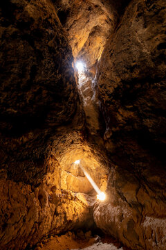 Mojave National Preserve, California: Light rays pass from the surface into the subterannean Cima lava tube. 