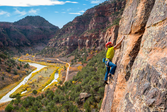 A man rock climbing in the Dolores River Canyon, Dove Creek, Colorado.
