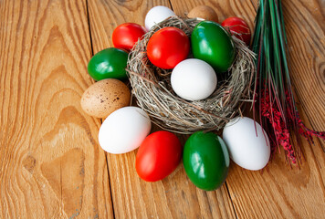 Happy Easter holiday background, Easter eggs as the color of the Italian flag - green, white, red in nest.