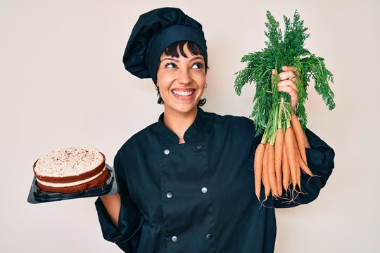 Beautiful brunettte woman chef cooking carrot cake smiling looking to the side and staring away thinking.
