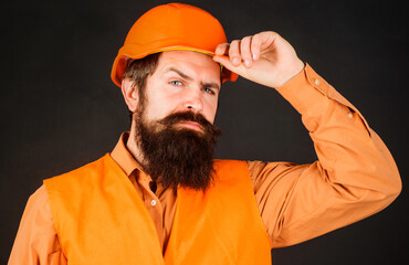 Professional Heavy Industry Engineer. Construction worker in hard hat. Bearded man in Safety Uniform and helmet. Male builder.