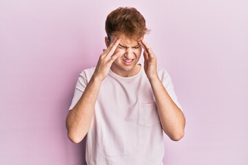 Young caucasian man wearing casual t shirt with hand on head, headache because stress. suffering migraine.