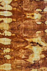 detail of a pattern in brown-ocher batik on a cotton fabric