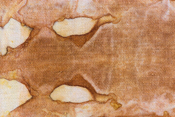 detail of a pattern in brown-ocher batik on a cotton fabric