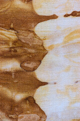 detail of a pattern in brown-ocher batik on a cotton fabric