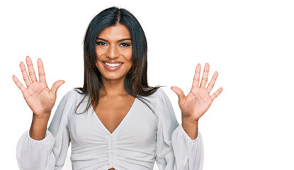 Young latin transsexual transgender woman wearing casual clothes showing and pointing up with fingers number ten while smiling confident and happy.