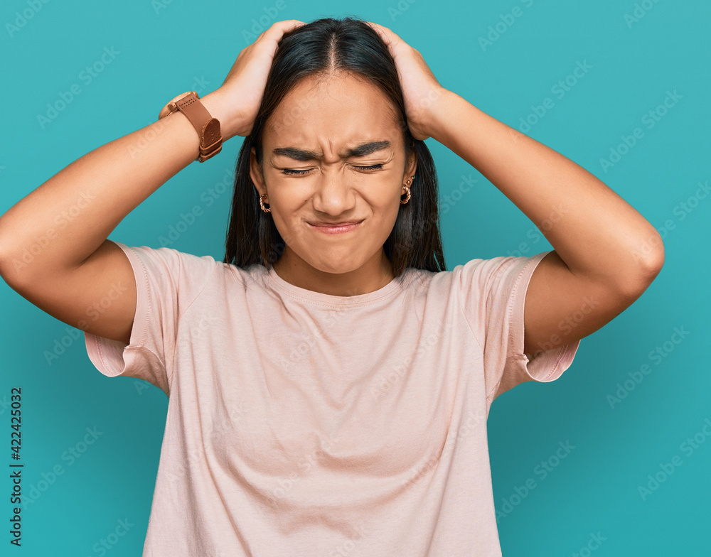 Sticker young asian woman wearing casual clothes suffering from headache desperate and stressed because pain