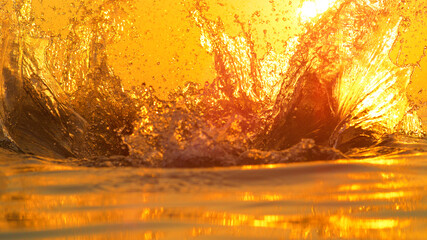 CLOSE UP: Detailed shot of crystal clear ocean water splashing into evening sky.