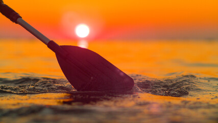 CLOSE UP: Scenic shot of the endless Adriatic sea at sunrise and rower's paddle. © helivideo