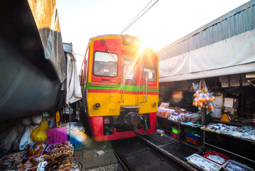 Umbrella Fresh Market with The Train on the Railroad Track, Mae Klong Train Station, Bangkok, Thailand on a Sunny Day