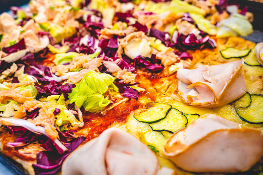 Clouse up of a pizzeria counter with pizza slices in display. Goumet, colorfull and healthy