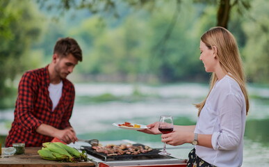 friends having picnic french dinner party outdoor during summer holiday