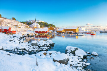 Awesome winter scenery of Moskenes village with ferryport and famous Moskenes parish Churc