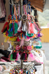 detail of several keychains with colorful dream catchers on display in a craft store