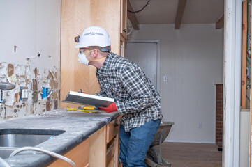 Electrician inspecting home construction