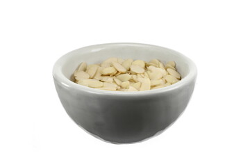 Blanched almonds flakes. Pile of peeled flaked almonds isolated on white.