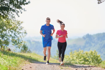 couple enjoying in a healthy lifestyle while jogging on a country road