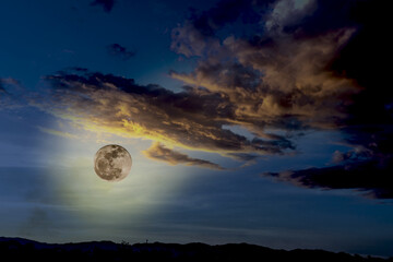 Naklejka na ściany i meble full moon over the moon with clouds at night 