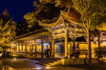 Fototapeta premium ZHANGYE, CHINA - AUGUST 22, 2018: Evening view of a pavilion on a square in Zhangye, Gansu Province, China