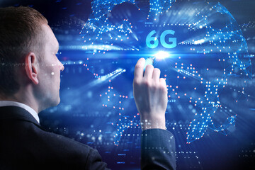 Business, Technology, Internet and network concept. Young businessman working on a virtual screen of the future and sees the inscription: 6G