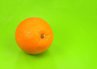 Fresh Ripe orange fruit on a green background. 