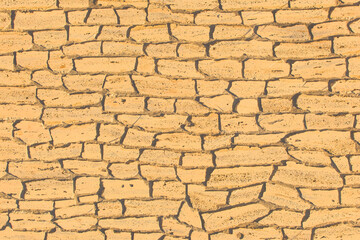 Sand color light yellow old stone brick wall ancient texture background