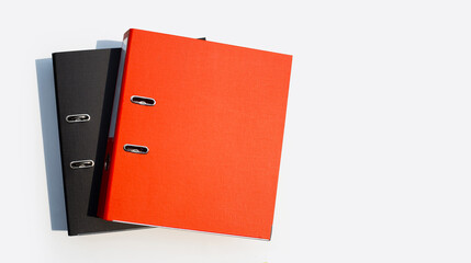 Red and black office folders on white background.
