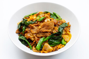 Stir fried flat noodle and pork with soy sauce.