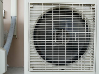 closeup of air conditioner compressor outside building. 