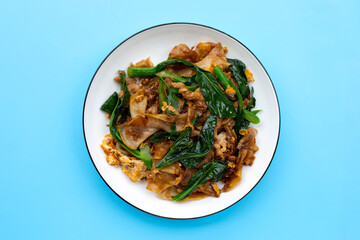 Stir fried flat noodle and pork with soy sauce.