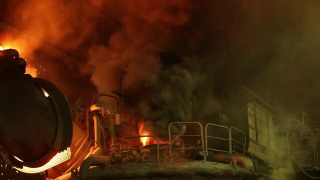 Blast furnace is spitting fire in a steelwork