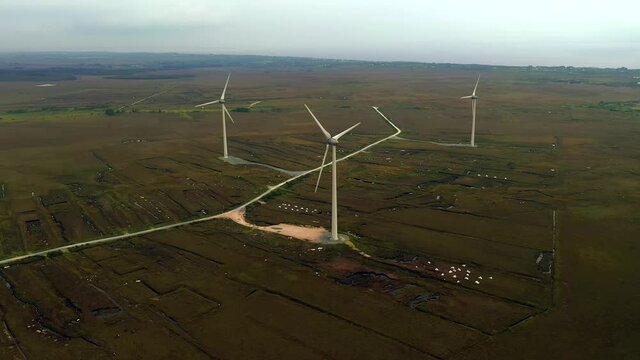 Wind Turbines at Moycullen Bogs, Connemara Bog Complex, Galway, Ireland, August 2020. Drone faces East and while slowly tracking away from a wind farm near Spiddal.