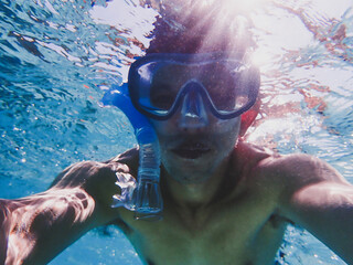 Man doing underwater selfie photography