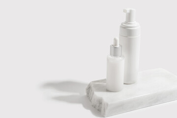 Foam container and bottle with serum on light background