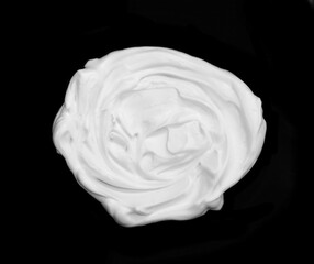 whipped cream or meringue isolated on black background. 