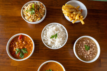 Obraz na płótnie Canvas food bowls: rice, seafood, shrimp, beans, chips - side dishes