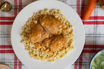 Classic chicken paprikash on a bed of Hungarian dumplings (Nokedli)