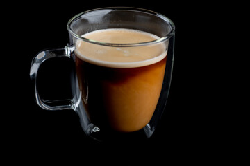 Coffee and cream in a glass mug 