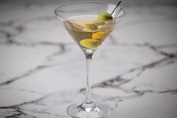 Extra dirty martini served on a marble background 