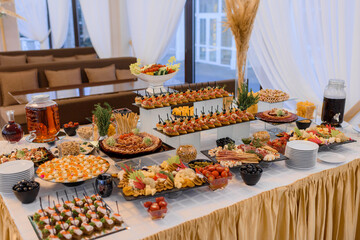 Professional serving table with a variety of snack food on the banquet.
