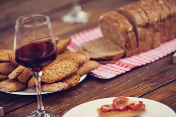 composition with a glass of red wine and toasted bread